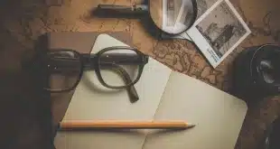 Bureau de voyage avec sac à dos, carnet et cartes pour préparer un tour du monde