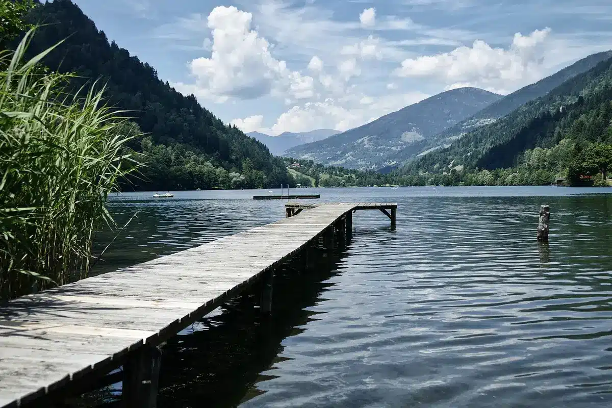 Passerelle en bois menant à une cabane sur un étang en plein jour